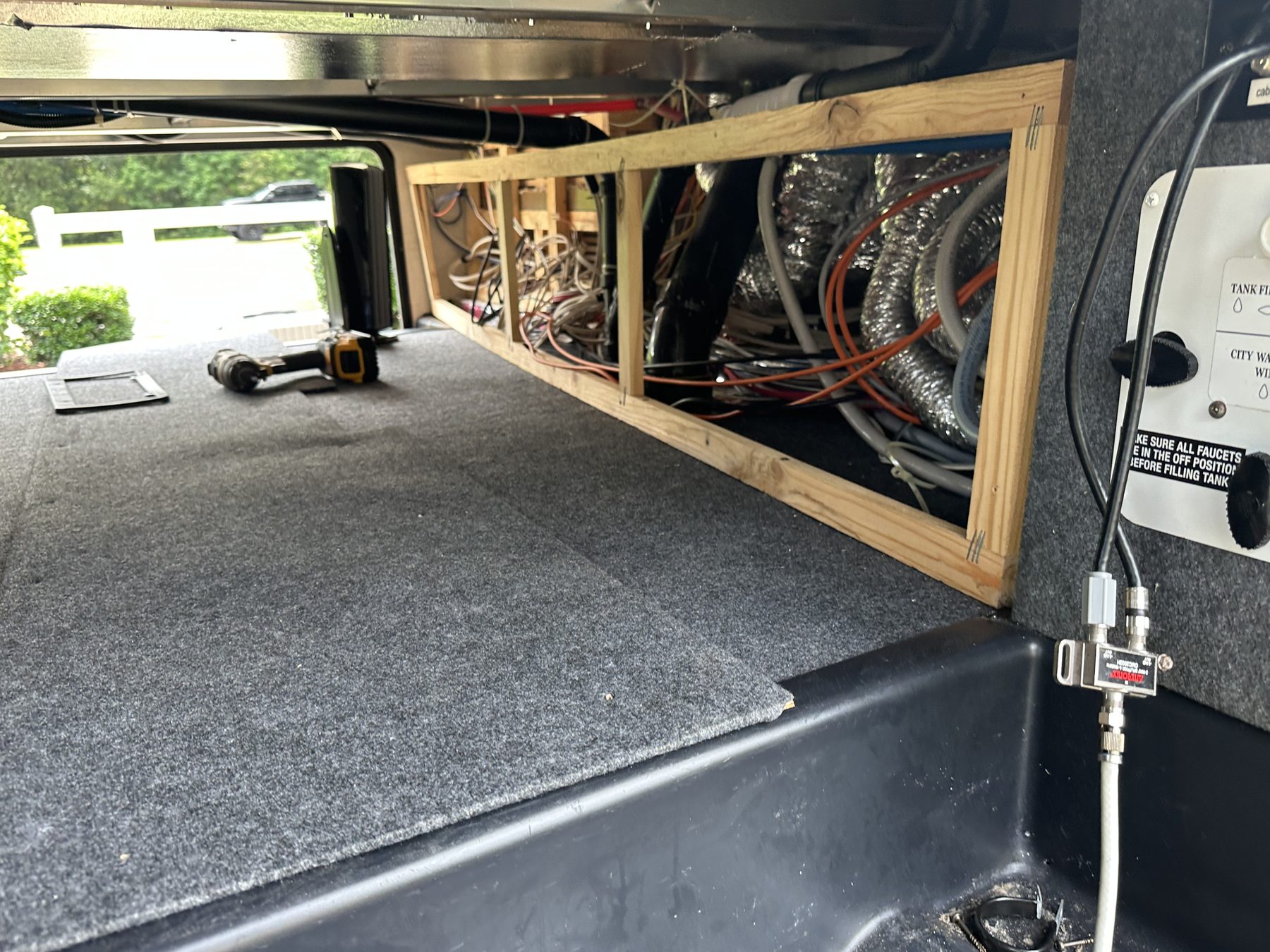 RV underbelly plumbing lines repaired below the floor
