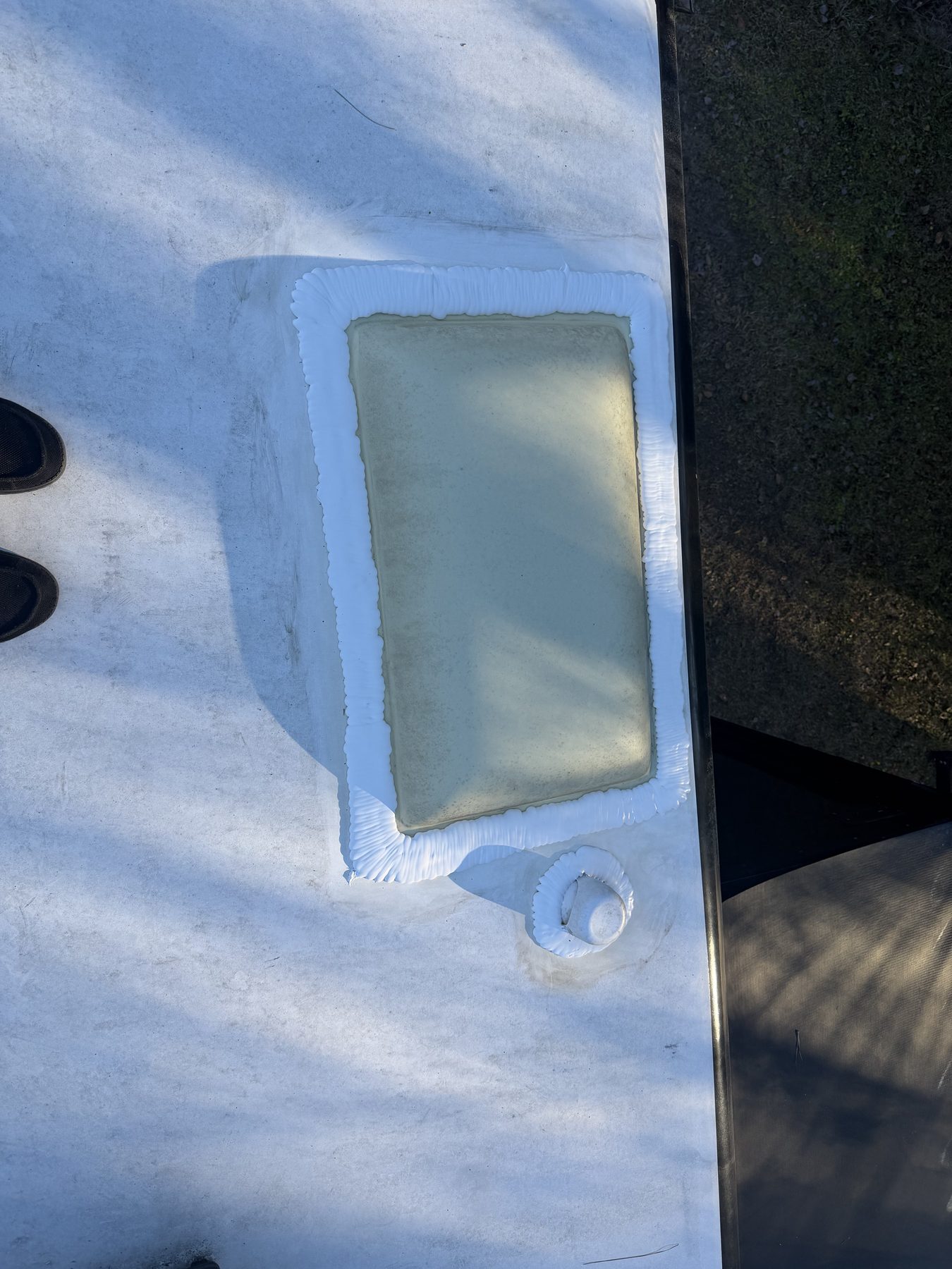 RV skylight and roof sealant repair close-up