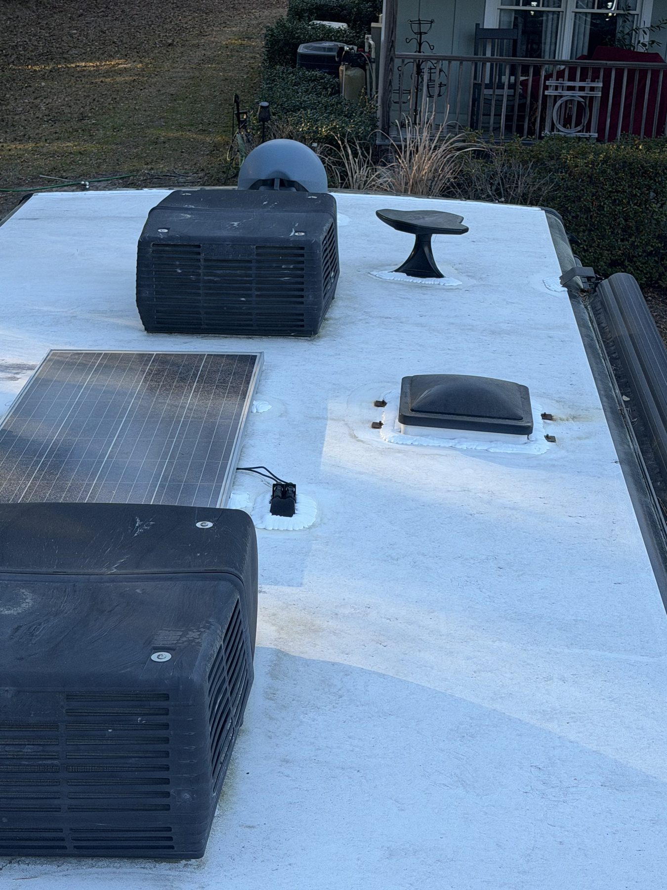 RV roof with solar panels vents and AC units